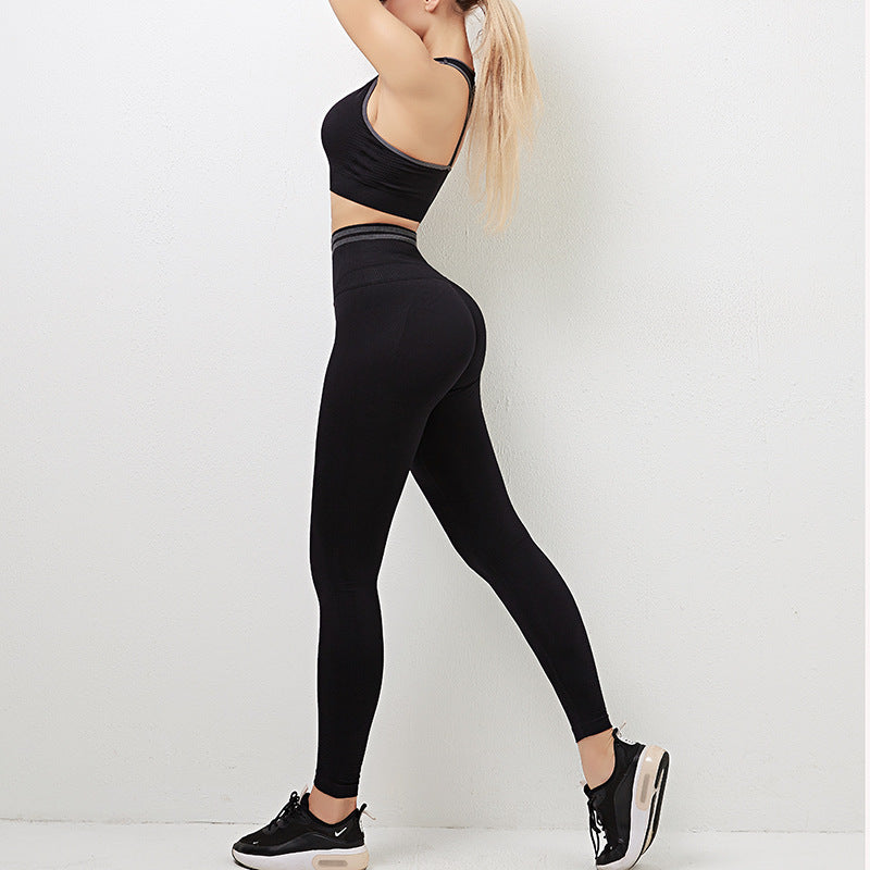Women's Seamless Sports Bra & High-Waist Leggings Gym Set shown on model — black colour, round neck sports bra, high-waist seamless leggings, contrast trim — Fifi London Spring collection