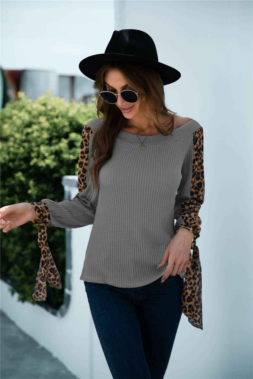 Women's off-shoulder leopard print sleeve knitted top shown front-on on model — Fifi London