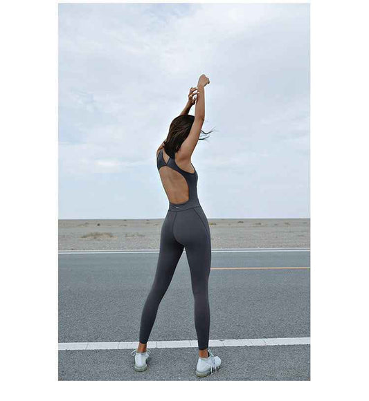 Women's Seamless Sleeveless Yoga Jumpsuit shown flat lay — purple colour, sleeveless design, back hollow cut-out, padded built-in bra, full-length sports tights — Fifi London Spring collection