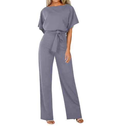 Women's Short Sleeve Tie Waist Jumpsuit shown front-on on model — nude/beige colour, boat neck, tie belt, straight-leg trousers — Fifi London clubwear collection