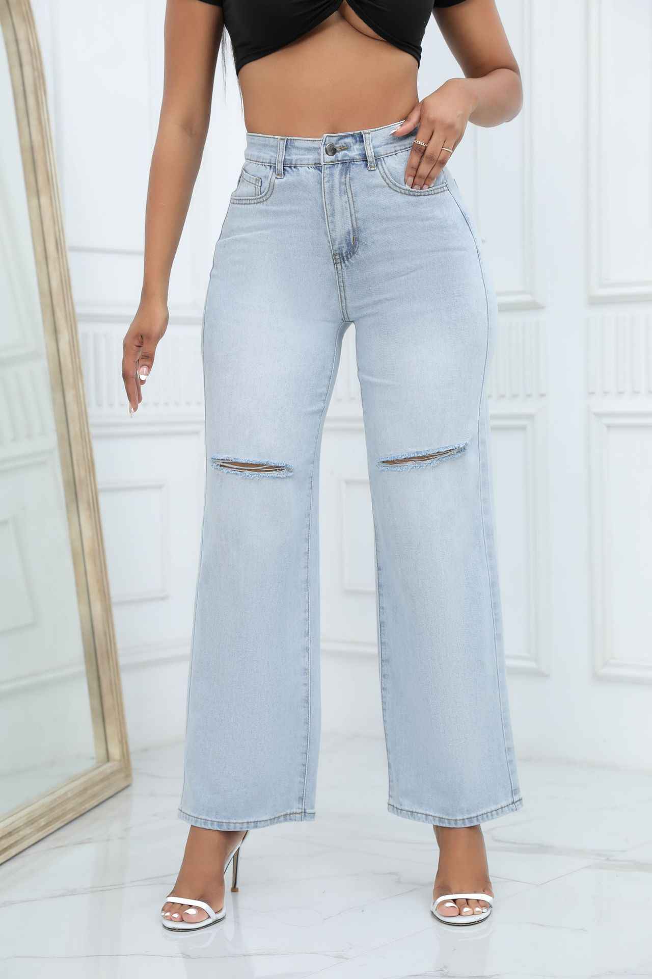 Elegant Ripped Denim Trousers shown front-on on model — Fifi London Autumn collection