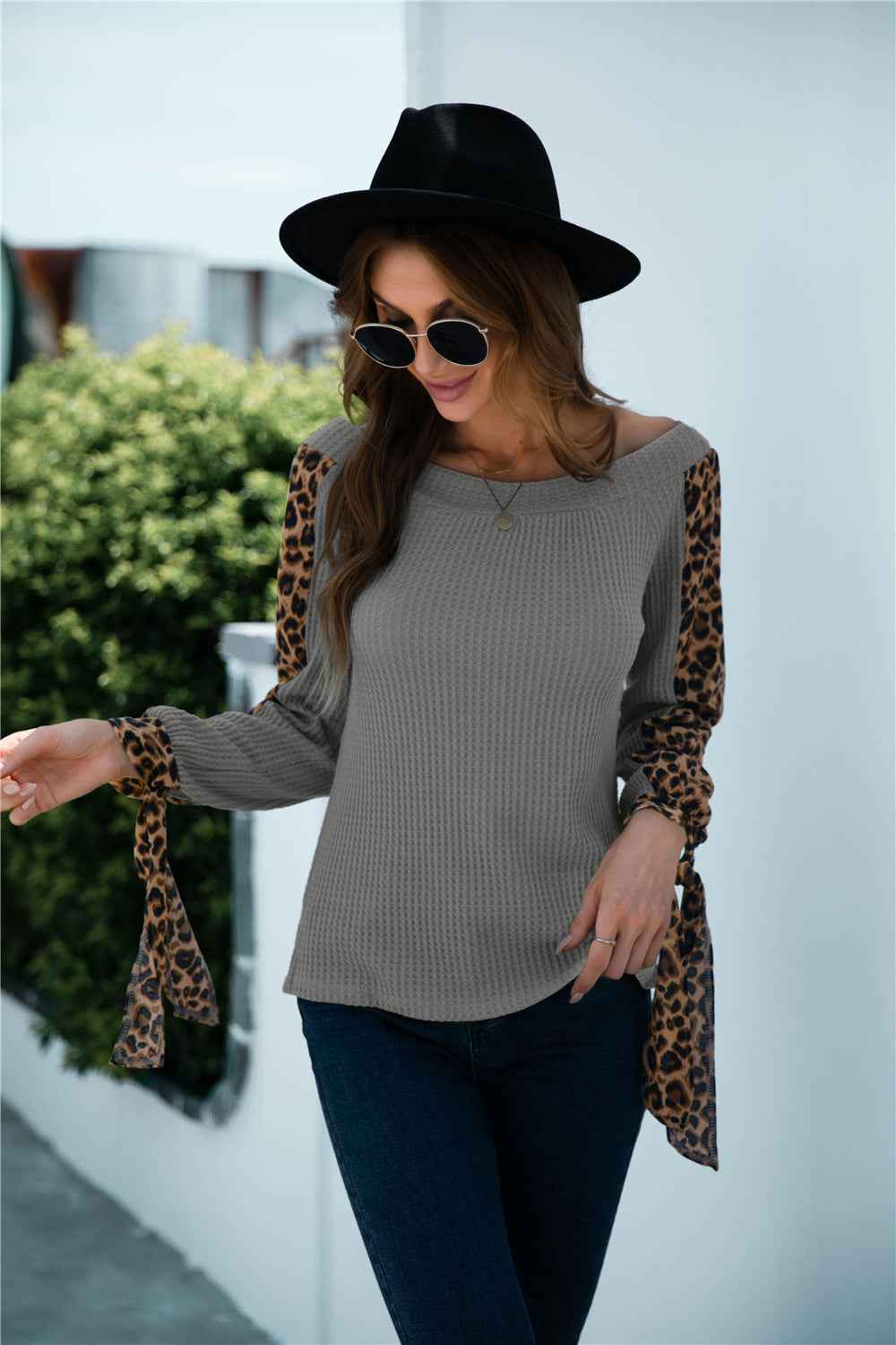 Women's off-shoulder leopard print sleeve knitted top shown front-on on model — Fifi London 