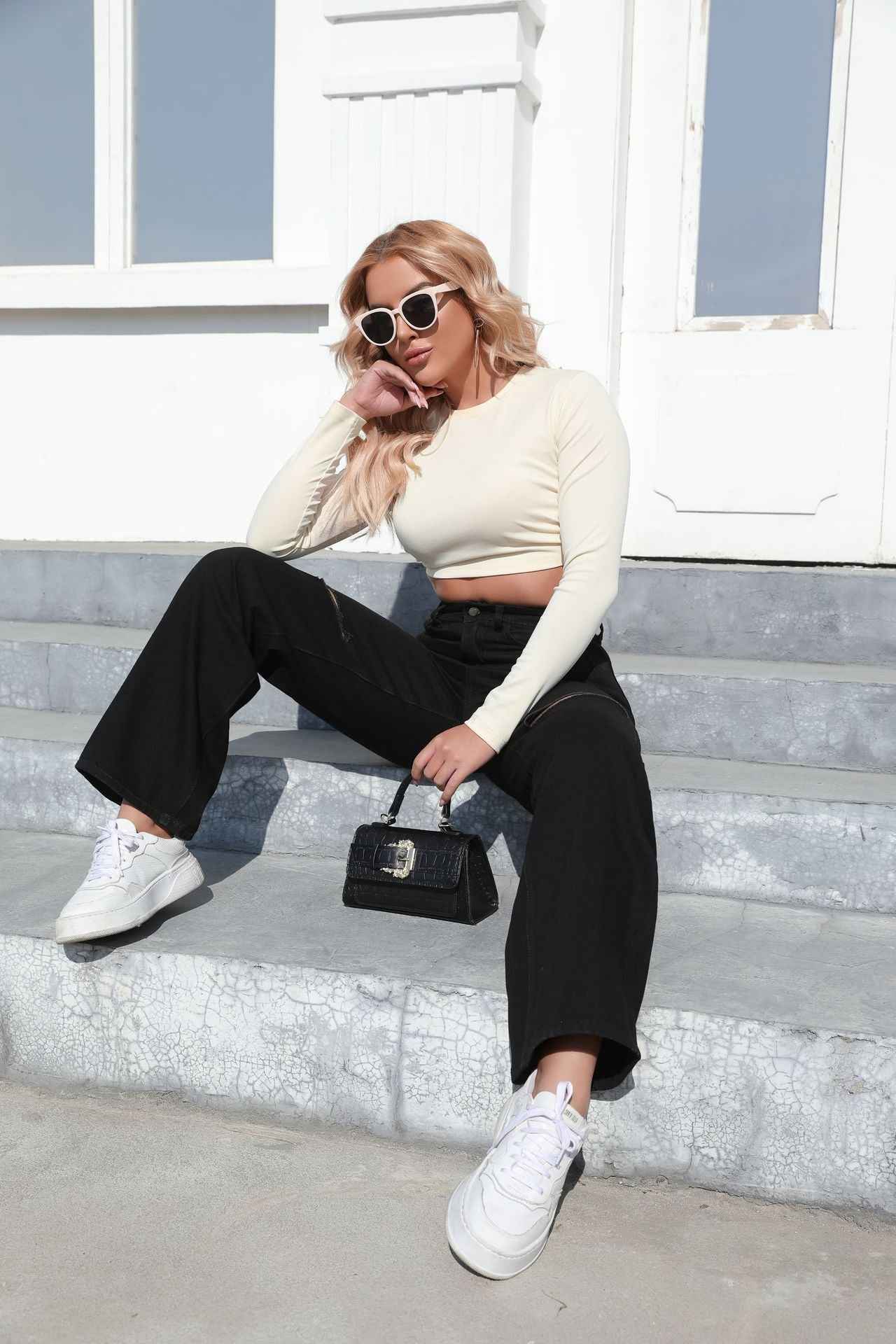Elegant Ripped Denim Trousers shown front-on on model — Fifi London Autumn collection