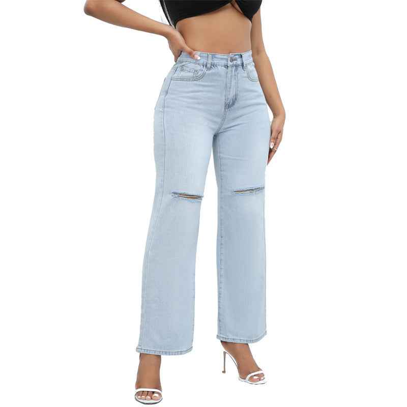 Elegant Ripped Denim Trousers shown front-on on model — Fifi London Autumn collection