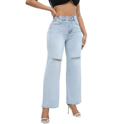 Elegant Ripped Denim Trousers shown front-on on model — Fifi London Autumn collection