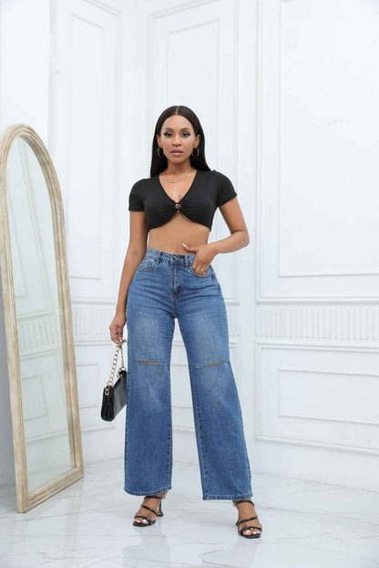 Elegant Ripped Denim Trousers shown front-on on model — Fifi London Autumn collection